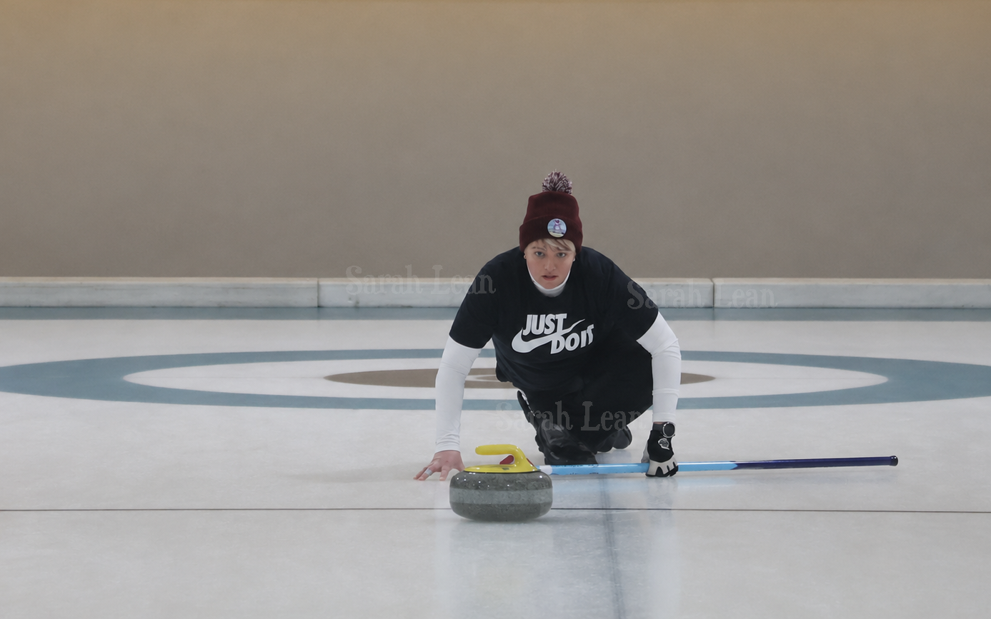 Sarah delivering a curling stone on the ice